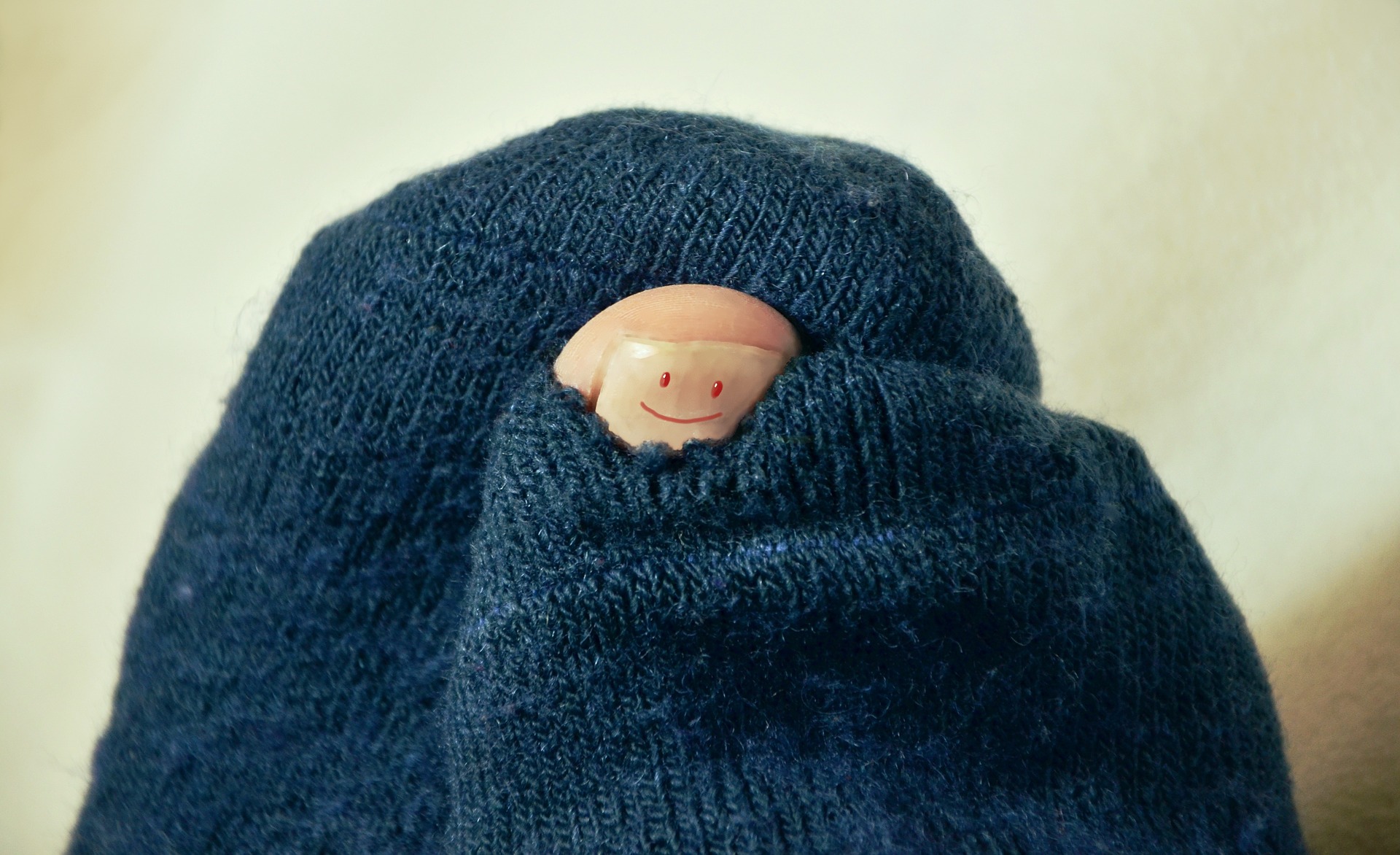 Toe poking through sock with smiley on big toe